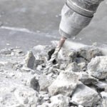 Drilling machine breaking concrete floor